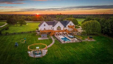 Aerial view of backyard oasis, pool, hot tubs & fire pit.