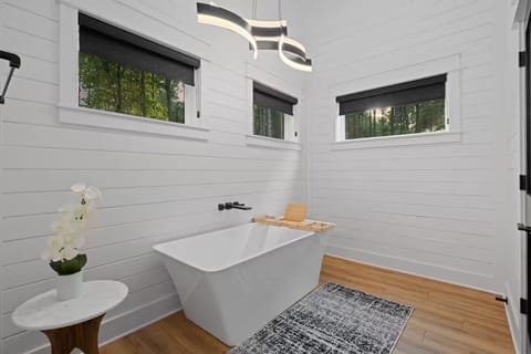 Bathroom Retreat: Soak in style with modern fixtures and serene forest views!