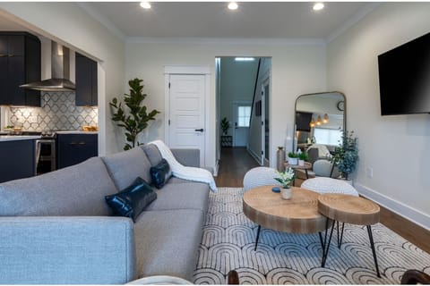 Open living area with comfortable seating, smart tv, and easy flow to kitchen