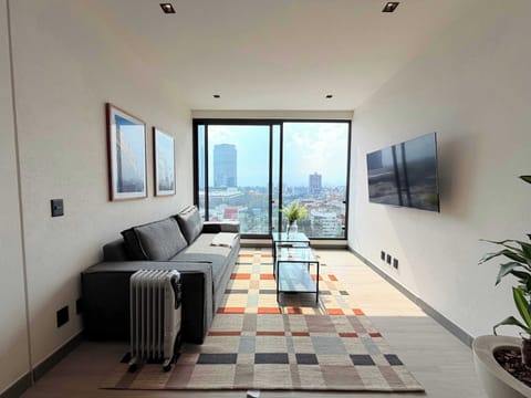 Bright and comfortable living room with modern décor and large windows offering city views.