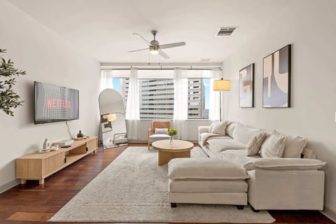 Open concept living area with a Smart TV, sectional seating, and thoughtfully styled decor. Designed to feel inviting and spacious, making it easy to relax or enjoy movie nights during your stay.