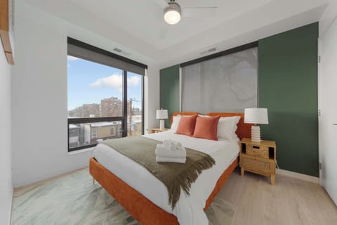A cozy and stylish bedroom with a comfortable bed, ample natural light, and beautiful city views. Relax in this peaceful retreat for a restful night’s sleep, featuring modern furnishings and a calm atmosphere.