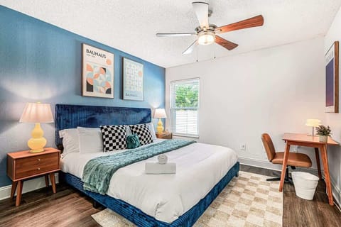 Bright bedroom with a comfy bed, chic artwork, and soft natural light. A cozy retreat perfect for restful nights.