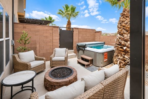 Private patio with hot tub, fire pit, and cozy resort-style seating