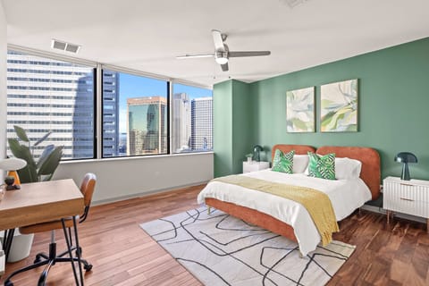 Wake up to skyline views and soft natural light streaming through large windows.