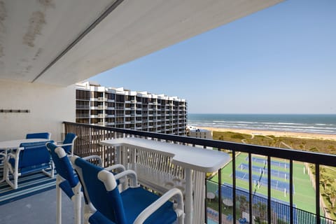 Oceanfront balcony with sweeping beach views and seating