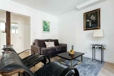 The large living room has a large sofa and several armchairs