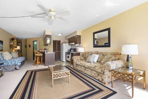 Unwind in your spacious open-plan retreat, where a cozy living area flows into a fully-equipped kitchen—perfect for preparing meals and relaxing together after a day of adventure.
