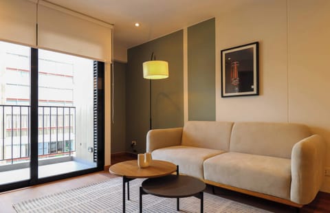 Cozy living room with a comfortable sofa and direct access to the balcony.