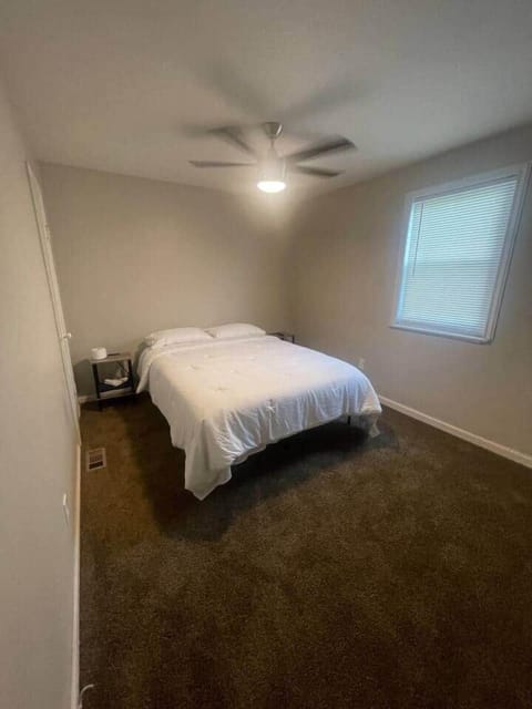 This inviting bedroom includes a queen-sized bed, and a window that provides natural light and a lovely view. 