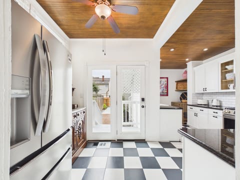 Step into a kitchen that blends character and charm with effortless function. From morning coffee beneath warm wood ceilings to evenings spent cooking together, this bright, inviting space makes everyday moments feel special.