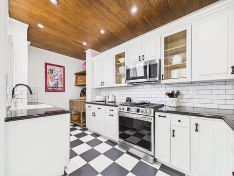 This kitchen invites you to slow down and savor the simple pleasures. Cook beneath warm wood ceilings, share stories over a timeless checkerboard floor, and enjoy a space where classic design and everyday comfort come together effortlessly.