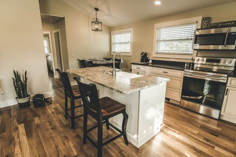 Bright, fully stocked kitchen with dining area for extended stays in Brevard NC