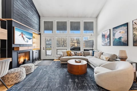 Spacious, modern living room with vaulted ceilings and golf course views