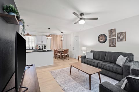 Spacious Living Room with Large TV, Comfortable Sofa, and Open Flow