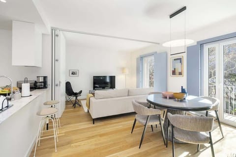The dining area features a spacious table and chairs, perfect for enjoying meals together.  