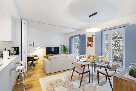 The dining area features a spacious table and chairs, perfect for enjoying meals together.  