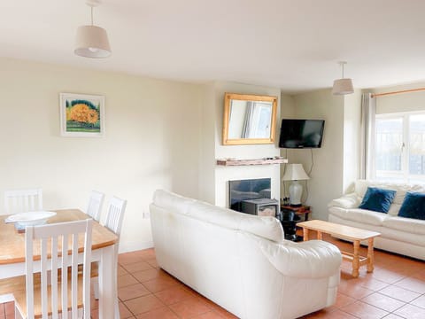 Seacliff Holiday Home No 43. Dining, living room open space with stove.