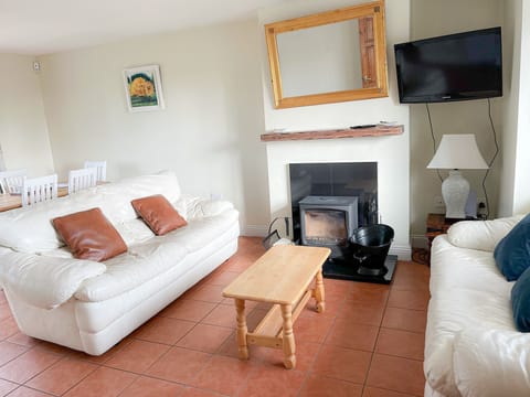 Seacliff Holiday Home No 43. Living room, rustic floors, bright patio window.