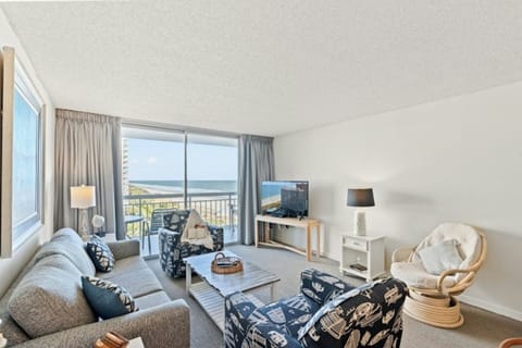 Gather together in this ocean view  living room for a family game night.