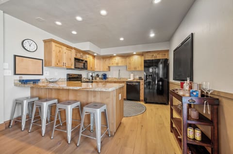 Your gourmet kitchen awaits with granite counters, modern appliances, and bar seating for memorable meals together.