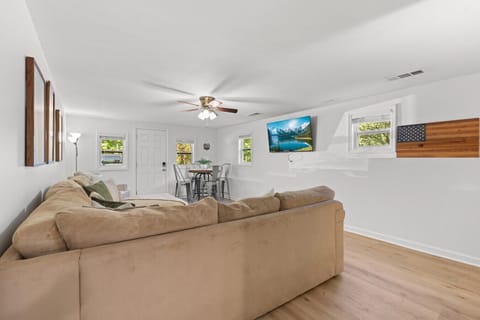 Comfortable private living space with oversized seating, dining area, and TV, designed for relaxing stays, movie nights, and extra room to spread out.