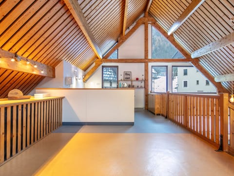 The charming reception area showcases traditional Savoyard architecture, inviting guests to unwind while overlooking the picturesque mountains of Saint-Colomban-des-Villards.