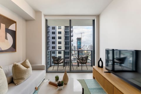 Sun-filled living space with skyline views & balcony access