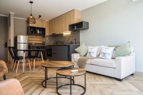 Cozy and stylish living space with modern kitchen and dining area, perfect for a relaxing stay in the heart of the city.
