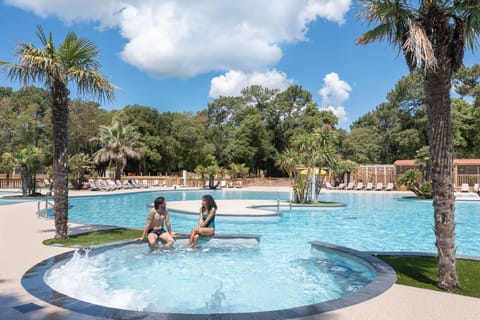 Surrounded by lush greenery, this inviting pool offers a tranquil escape, ideal for cooling off in nature-inspired surroundings.