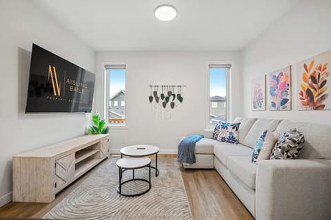Main floor living room with a Smart TV with cable, a cozy sectional and board games.