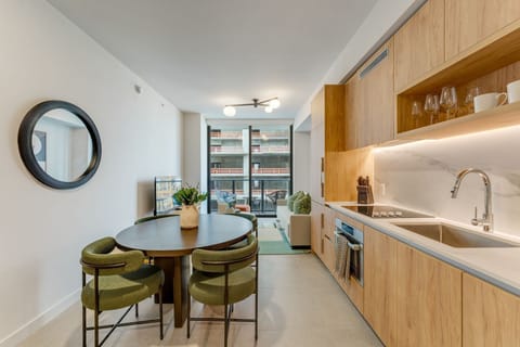 Sun-filled living space with skyline views & balcony access