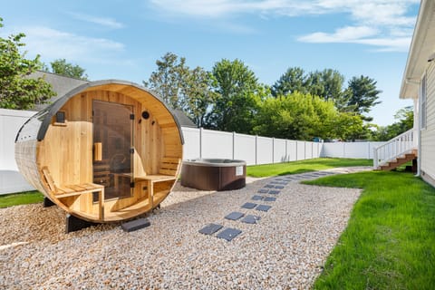 Unwind in the private hot tub or barrel sauna inside the fenced backyard.