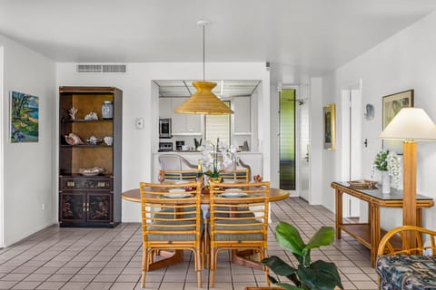 Spacious dining area with natural textures and built‑in shelving offers a comfortable gathering place with seamless kitchen access