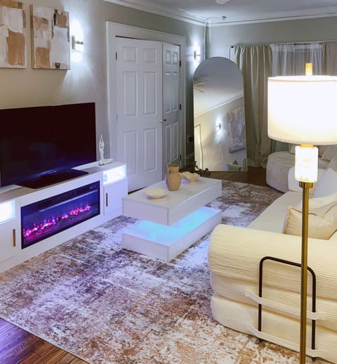 Living room area with sofa bed and fireplace.