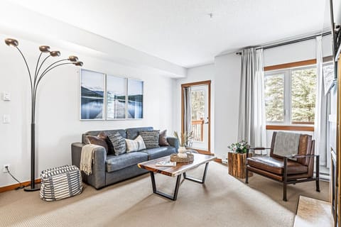 Relaxing living area with 55` Smart TV, cozy fireplace, and a Queen sofa bed.