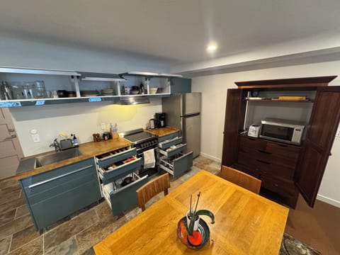 Fully stocked kitchen with microwave, oven and toaster