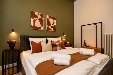 Relax in this beautifully appointed bedroom with comfortable bedding, modern furnishings, and thoughtful design touches that create a peaceful retreat for guests.