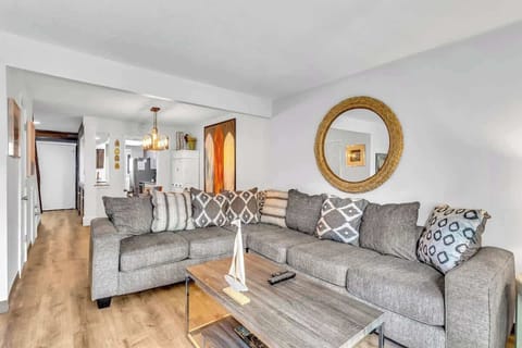 Sink into plush gray sectional seating where thoughtful textures and warm lighting create your perfect retreat.