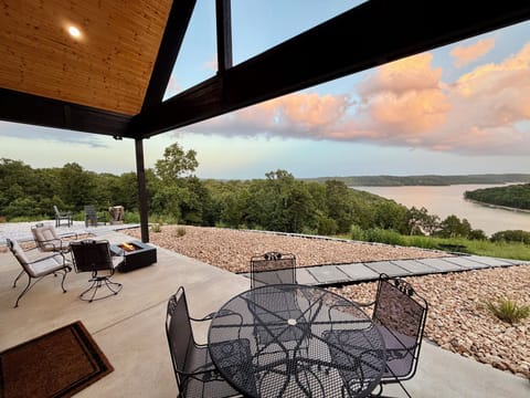 Covered patio with breathtaking Beaver Lake views and cozy fire pit
