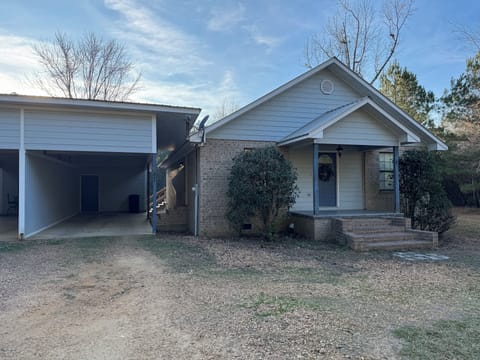 Front of house with a covered carport.