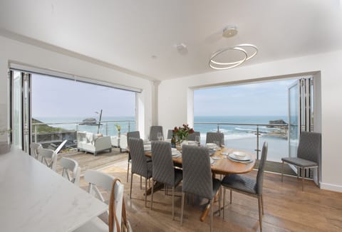 Seaside House, Portreath. Dining area with floor-to-ceiling doors providing a magnificent ocean backdrop
