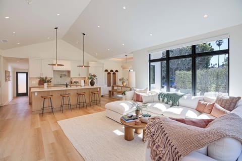 Relaxing indoor living and dining space with large windows and airy feel