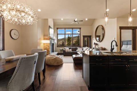Step into your open-concept retreat where elegant fixtures, a cozy fireplace, and stunning mountain views create the perfect backdrop for your mountain escape.
