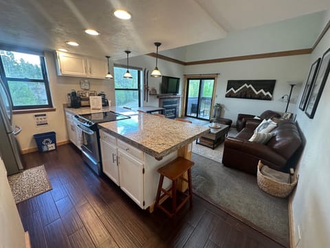 Well-equipped kitchen with seating for 6 at the island and a small table for 4.