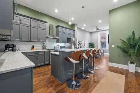 Contemporary, open-concept kitchen. Bright, luxurious space, dining table & TV