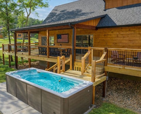 Large Wrap-Around Deck with a Firepit, Plenty of Seating, Outdoor Dining Space, and an XL Swim Spa!