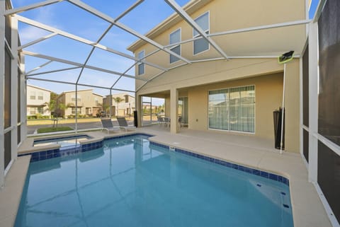Step outside to your private oasis with a sparkling pool and sleek screened enclosure. Relax on the inviting patio with comfortable lounge chairs, perfect for soaking up the sun and enjoying the lush views.