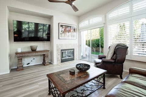 Living room with TV and sliding door to the outside