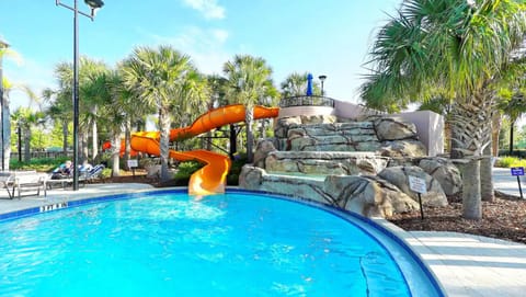 Relax by the resort pool featuring a fun water slide.